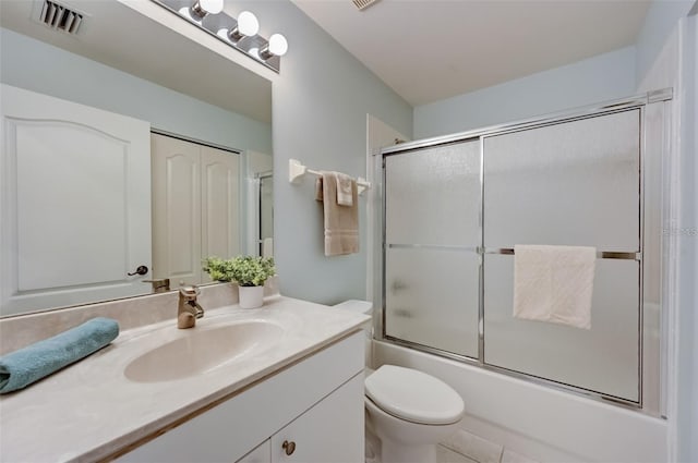 full bath with visible vents, shower / bath combination with glass door, vanity, and toilet