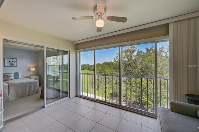 unfurnished sunroom featuring ceiling fan