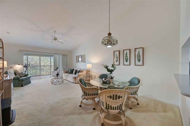 dining area featuring carpet floors, ceiling fan, and high vaulted ceiling