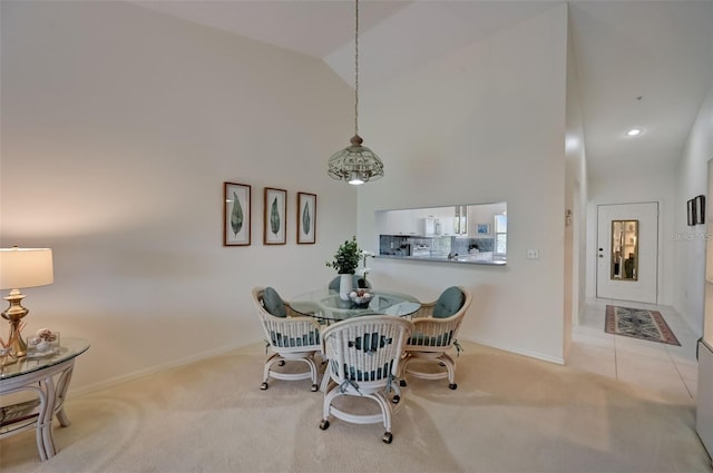 dining space featuring carpet floors, baseboards, high vaulted ceiling, and recessed lighting