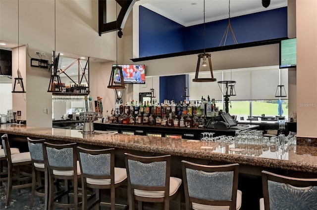 bar featuring a high ceiling and a community bar