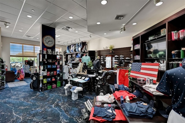 misc room featuring carpet floors, visible vents, and track lighting