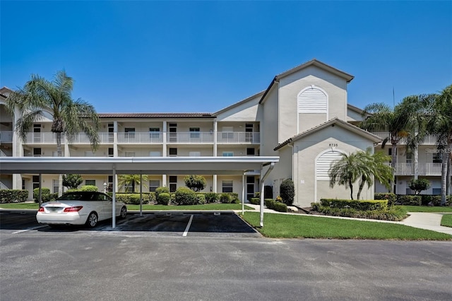 view of building exterior featuring covered parking