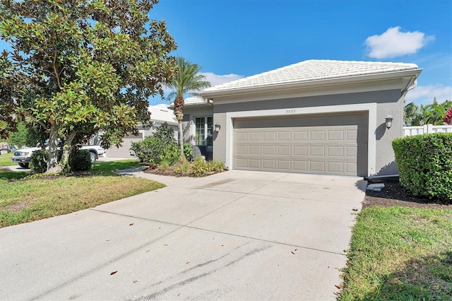 view of front facade featuring an attached garage, a front yard, concrete driveway, and stucco siding