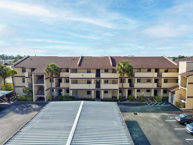 view of building exterior featuring uncovered parking