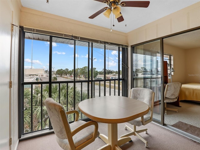 sunroom featuring ceiling fan