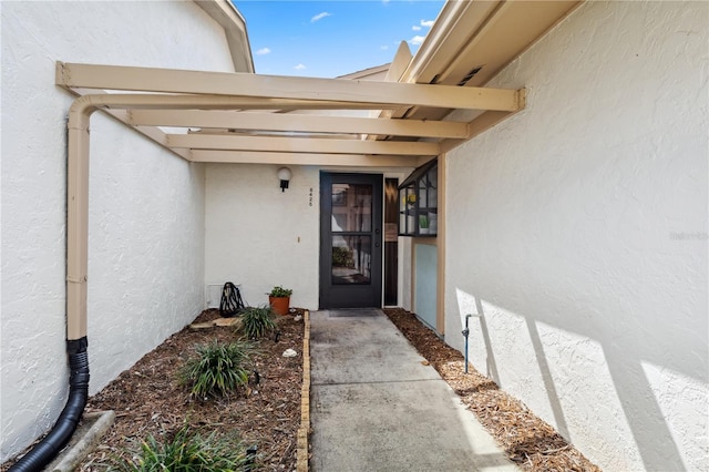 doorway to property with stucco siding