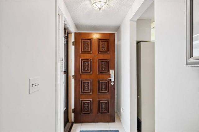 interior space featuring light tile patterned flooring and a textured ceiling