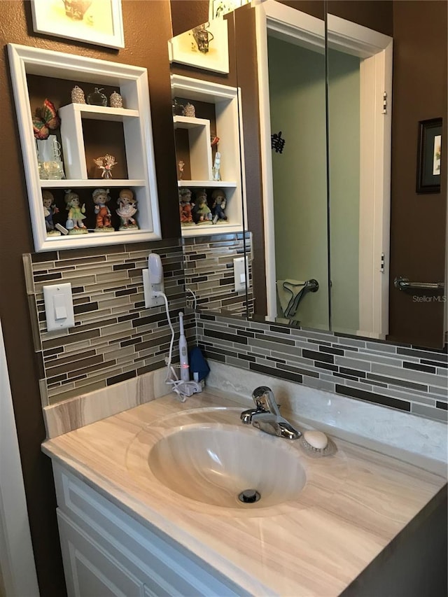 bathroom featuring tasteful backsplash and vanity