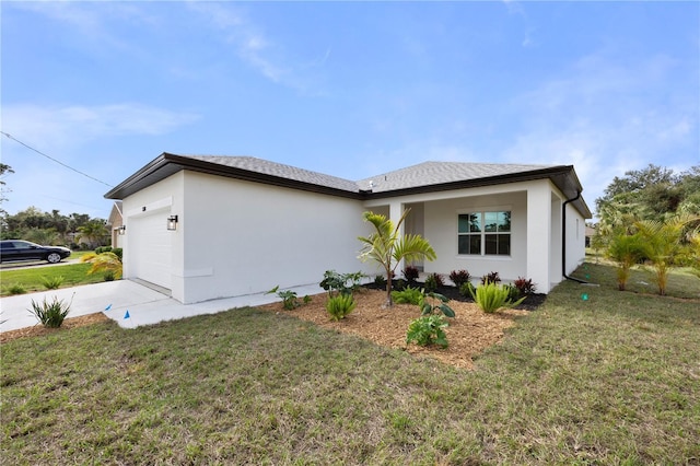 exterior space with an attached garage, driveway, a front lawn, and stucco siding