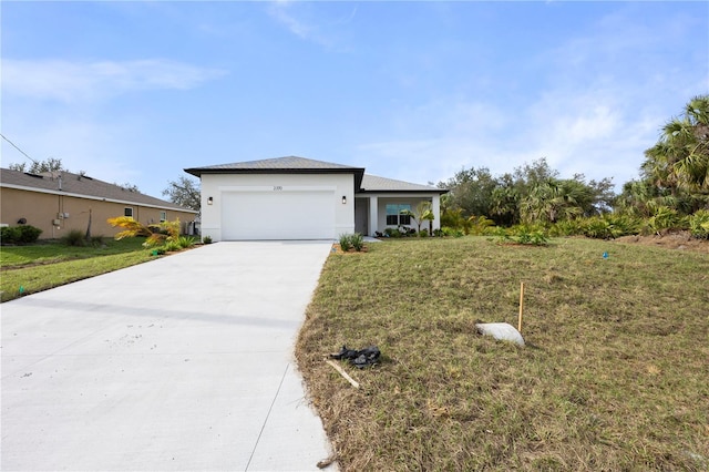 view of front of home featuring a garage, driveway, a front lawn, and stucco siding