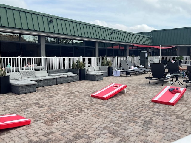 surrounding community featuring a patio, fence, and an outdoor living space