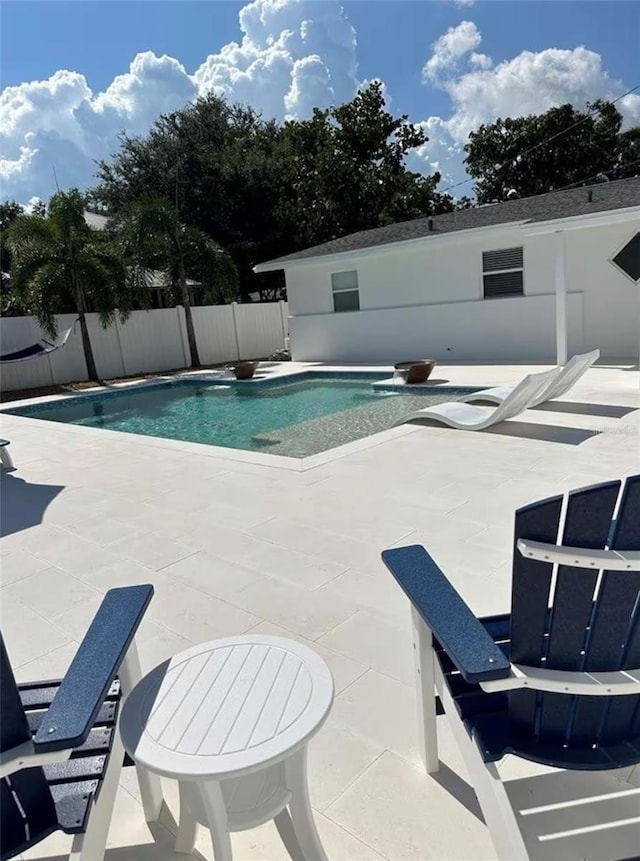 view of pool with a fenced in pool, fence, and a patio area