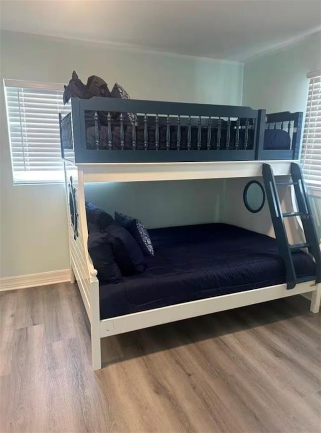 bedroom featuring baseboards and wood finished floors