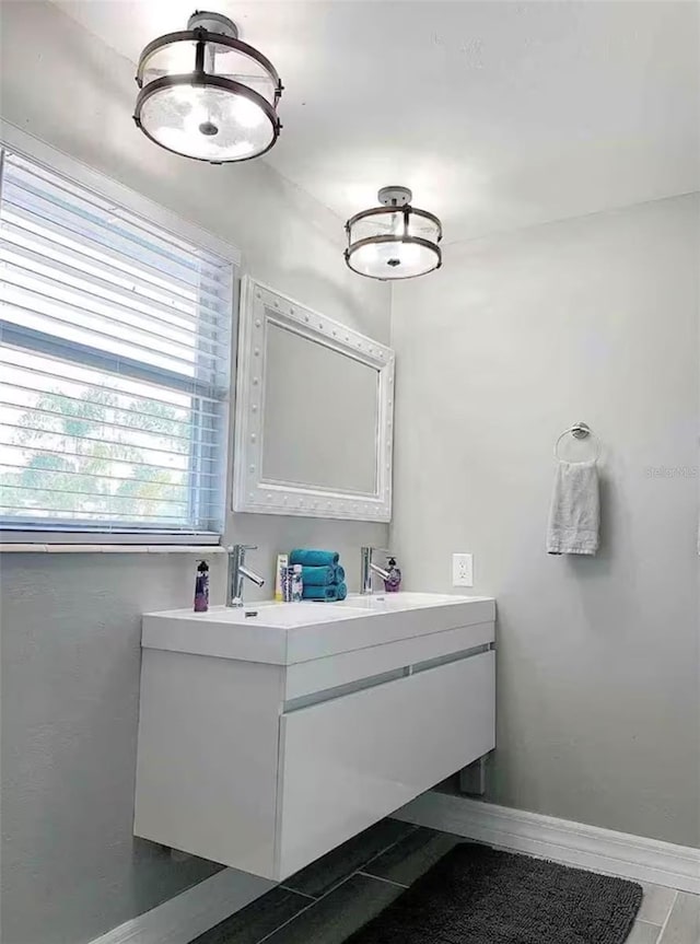 bathroom with baseboards and vanity