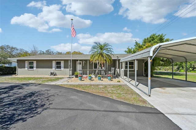 view of front of property with a shingled roof, concrete driveway, and stucco siding