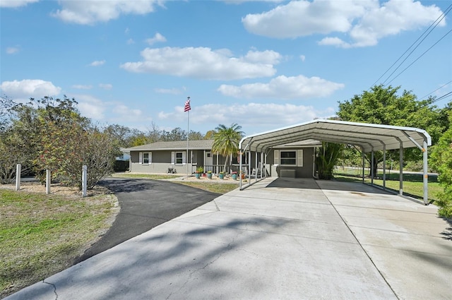 view of front facade with driveway and a detached carport