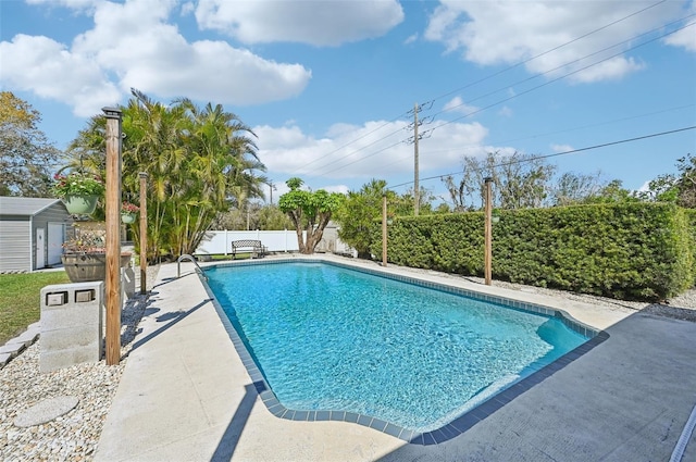 view of pool with a storage shed, a fenced in pool, a patio, a fenced backyard, and an outdoor structure