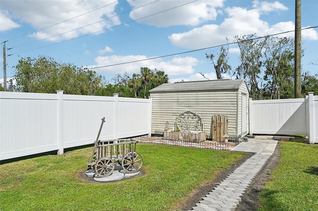 view of yard with a storage shed, a fenced backyard, and an outdoor structure