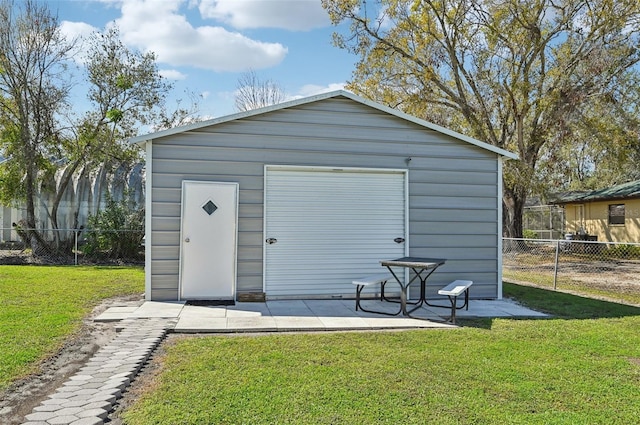 view of outdoor structure featuring an outbuilding and fence