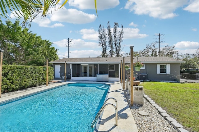 view of swimming pool featuring a fenced in pool, a yard, a sunroom, a patio area, and fence