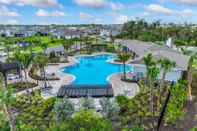 pool featuring a residential view, fence, and a patio