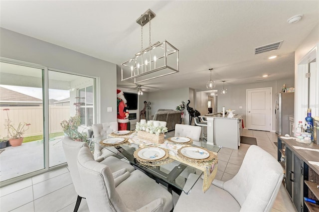 dining space featuring visible vents, a ceiling fan, and light tile patterned flooring