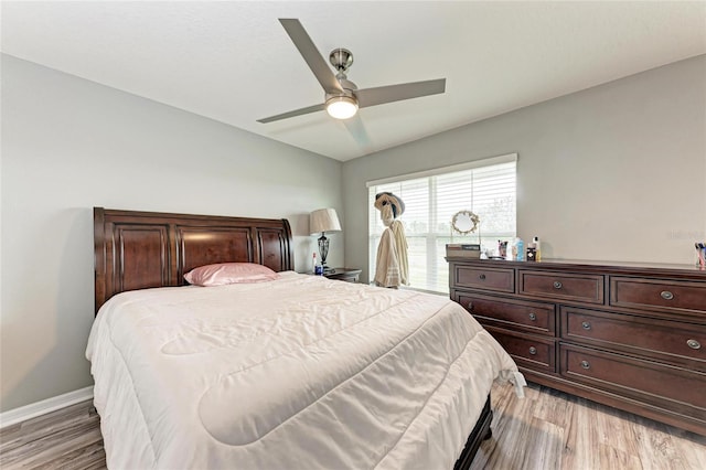 bedroom featuring ceiling fan, baseboards, and wood finished floors