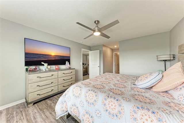 bedroom with ceiling fan, light wood-type flooring, and baseboards