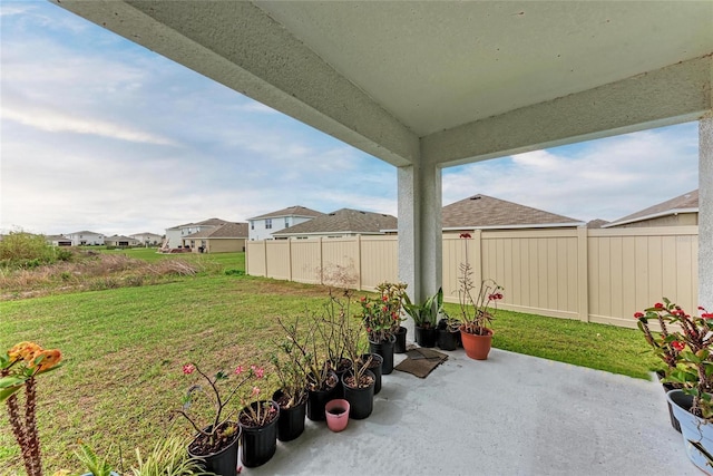 view of patio / terrace with a residential view and a fenced backyard