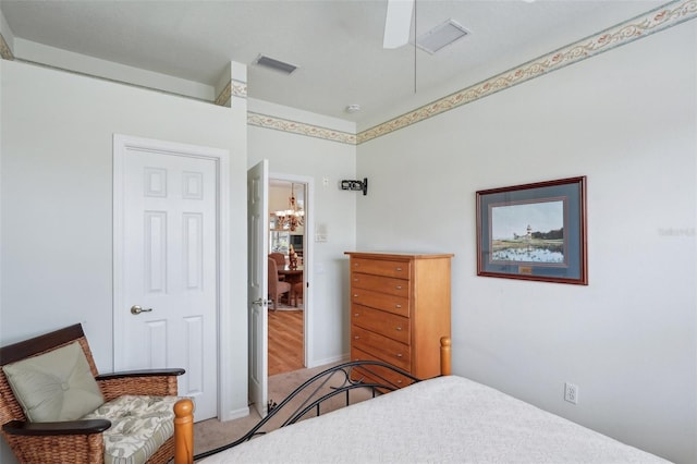 bedroom featuring carpet floors, visible vents, and ceiling fan