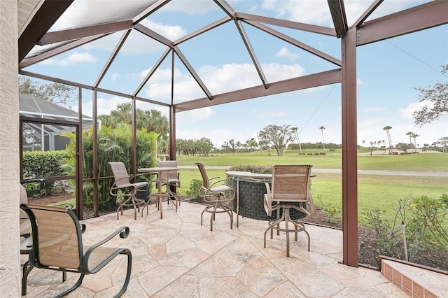 view of patio with glass enclosure and golf course view