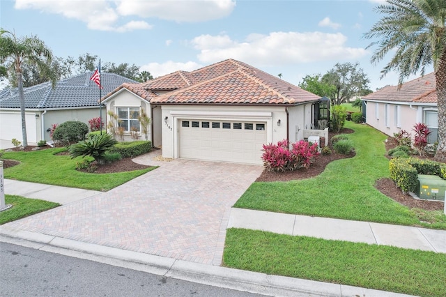 view of front of house featuring a garage, a tile roof, decorative driveway, a front lawn, and stucco siding