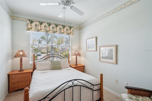 carpeted bedroom featuring a ceiling fan and baseboards