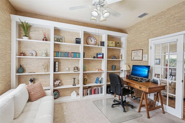 carpeted office space featuring a ceiling fan, visible vents, and wallpapered walls