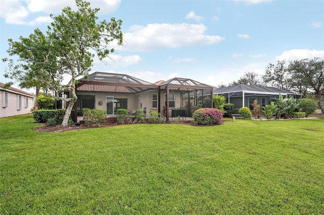 back of house featuring glass enclosure, a lawn, and stucco siding