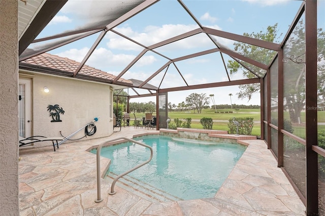 pool with glass enclosure and a patio area