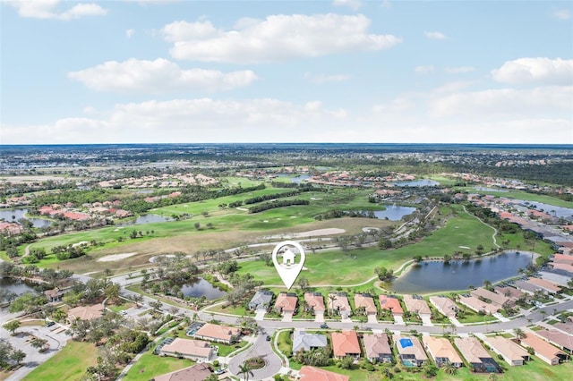 drone / aerial view with a residential view, a water view, and golf course view