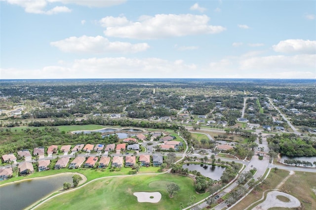 drone / aerial view with golf course view, a water view, and a residential view