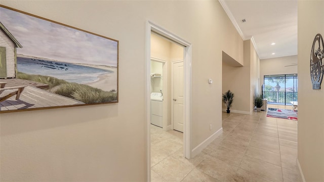 hall with washer / dryer, baseboards, ornamental molding, tile patterned floors, and recessed lighting