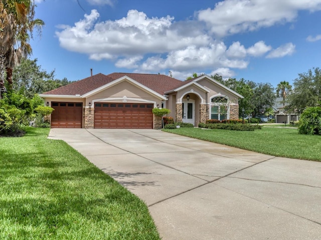 view of front facade featuring stone siding, a front lawn, an attached garage, and driveway