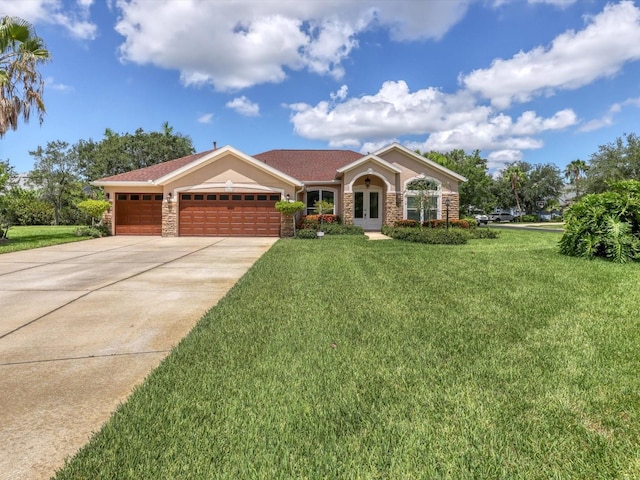 ranch-style house with concrete driveway, stone siding, an attached garage, french doors, and a front yard