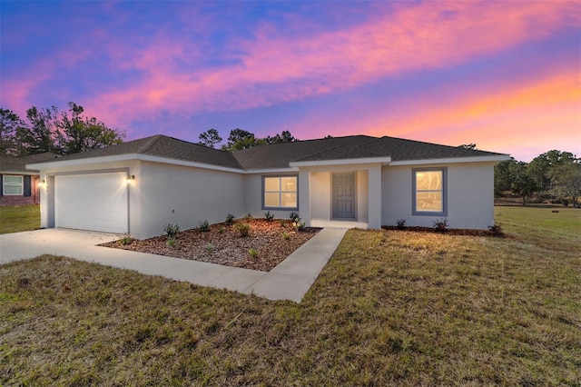 ranch-style house featuring a garage, driveway, a front lawn, and stucco siding