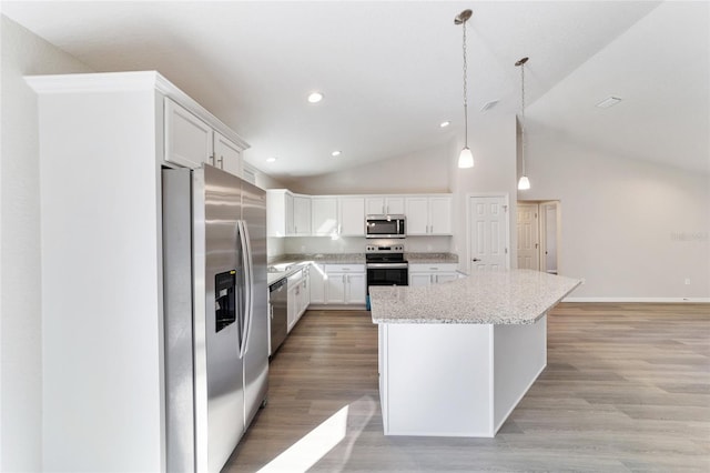 kitchen featuring a center island, pendant lighting, light wood finished floors, appliances with stainless steel finishes, and white cabinets