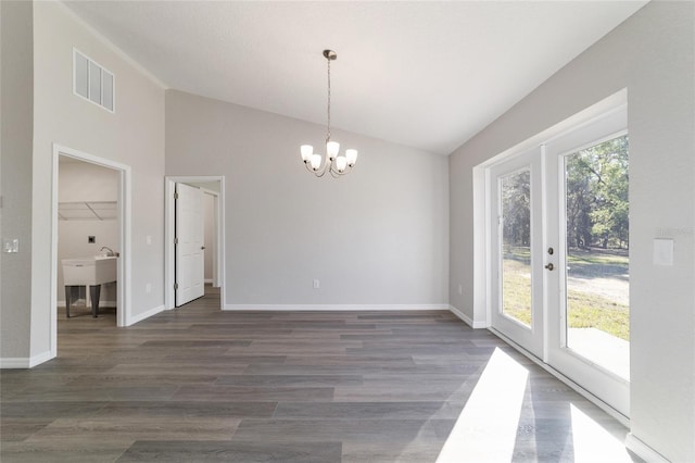 unfurnished dining area featuring baseboards, visible vents, dark wood-style flooring, and french doors