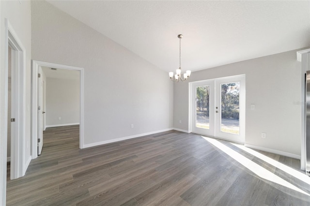 unfurnished dining area featuring french doors, a notable chandelier, dark wood-type flooring, high vaulted ceiling, and baseboards