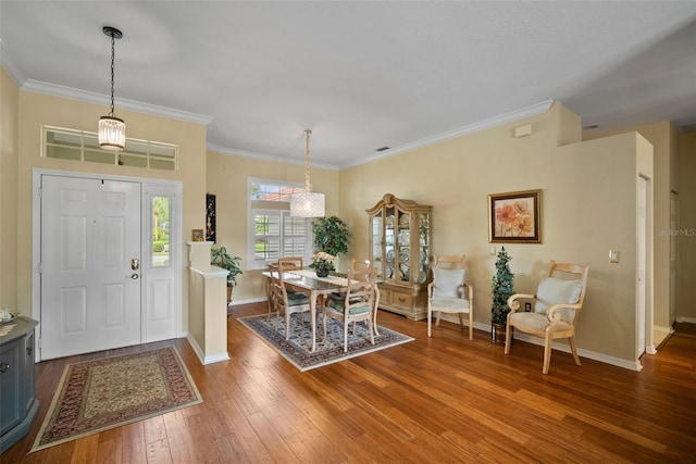 entrance foyer with baseboards, hardwood / wood-style flooring, and crown molding