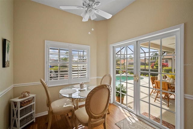 dining room with ceiling fan, french doors, and wood finished floors