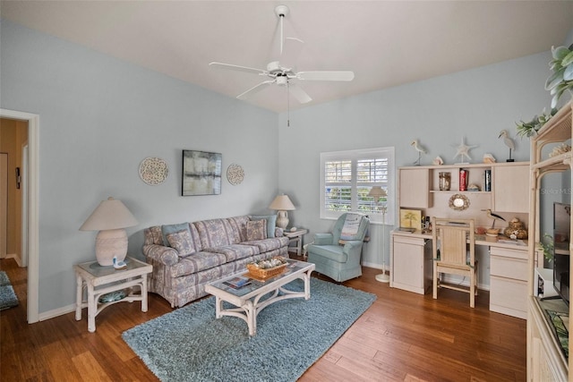 living room with ceiling fan, baseboards, and dark wood-style flooring