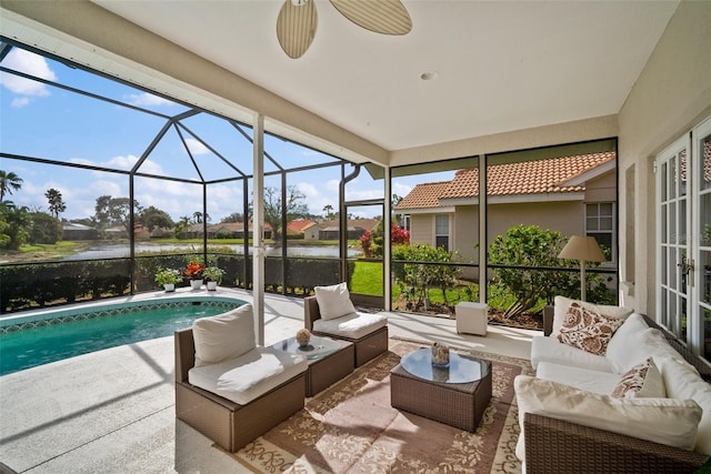 sunroom / solarium featuring a water view